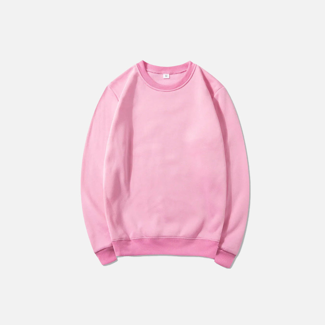 Front view of the pink Essential Pullover Sweatshirt in a gray background
