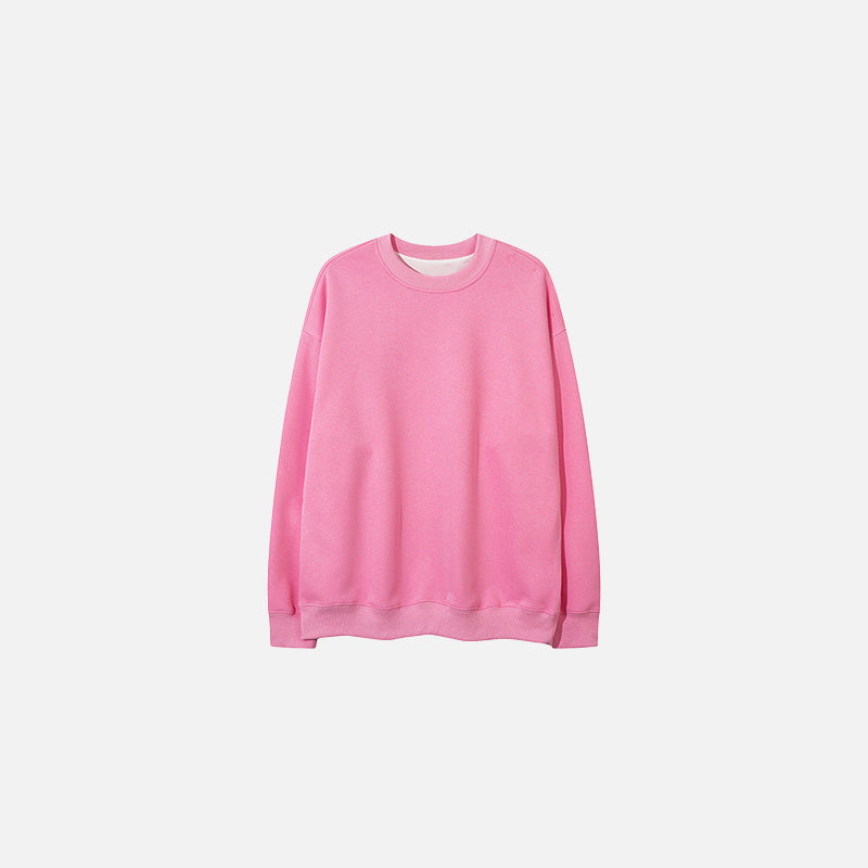Front view of the pink Classic Crewneck Sweater in a gray background