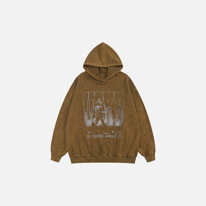 Front view of the brown Oversized Music Hoodie in a gray background 