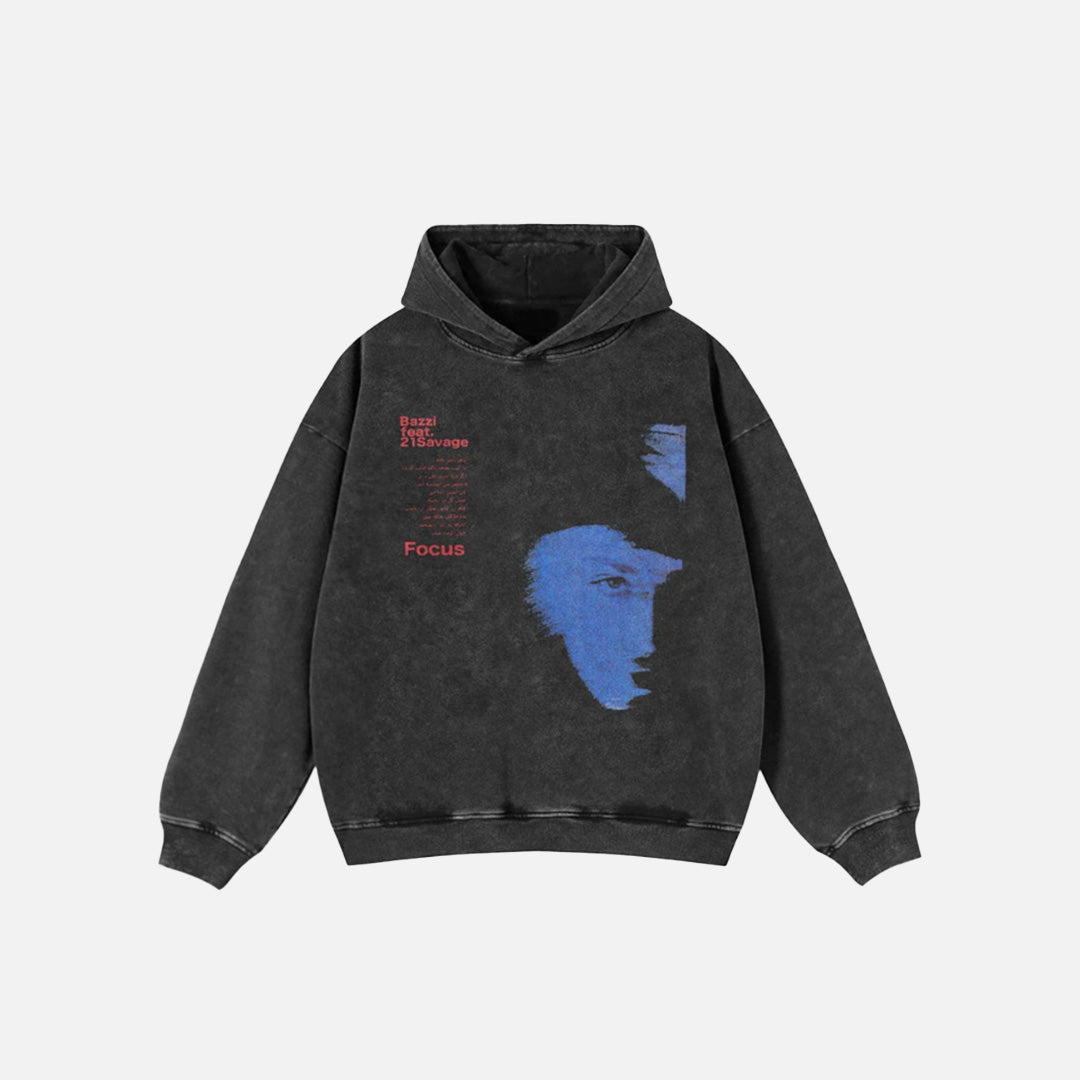 Front view of the black Y2K Focus Graphic Hoodie in a gray background