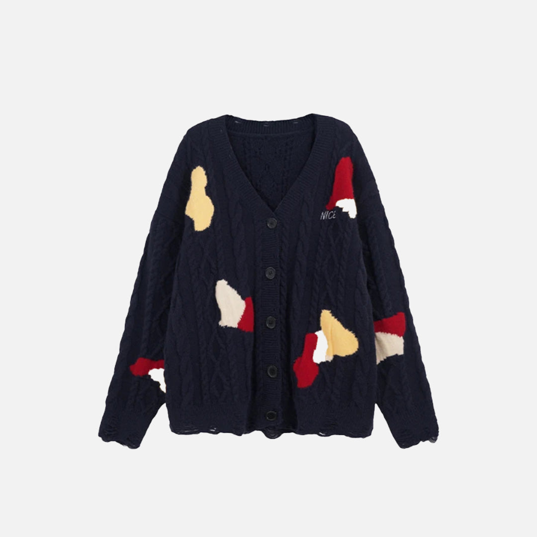 Front view of the navy blue Abstract Patch Cable Knit Sweater in a gray background