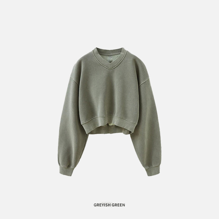 Front view of the grey green Women's Fleece Cropped Sweatshirt in a gray background