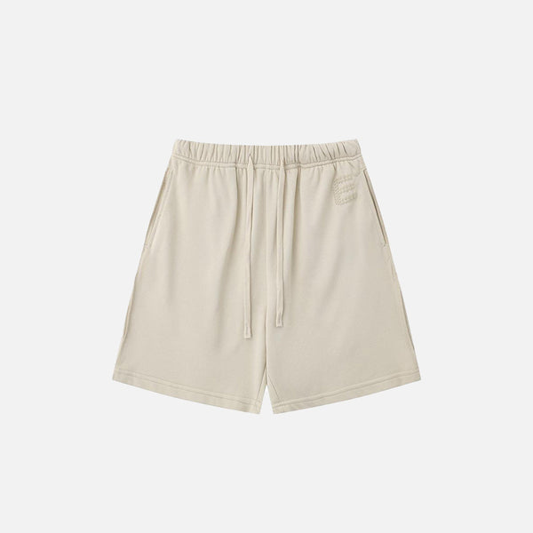 Front view of the beige Letter Print Loose Shorts in a gray background 