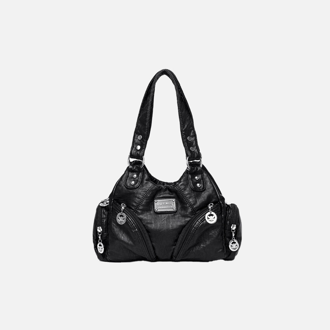 Front view of the black Utility Wanderer Handbag in a gray background