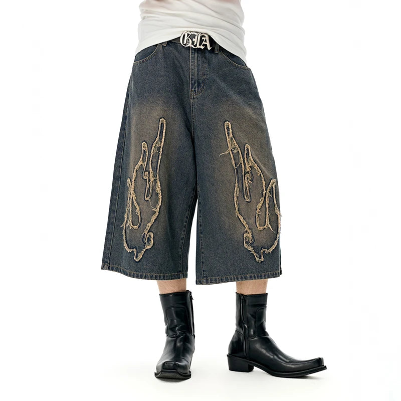 Model wearing the blue Edgy Chain Denim Shorts 