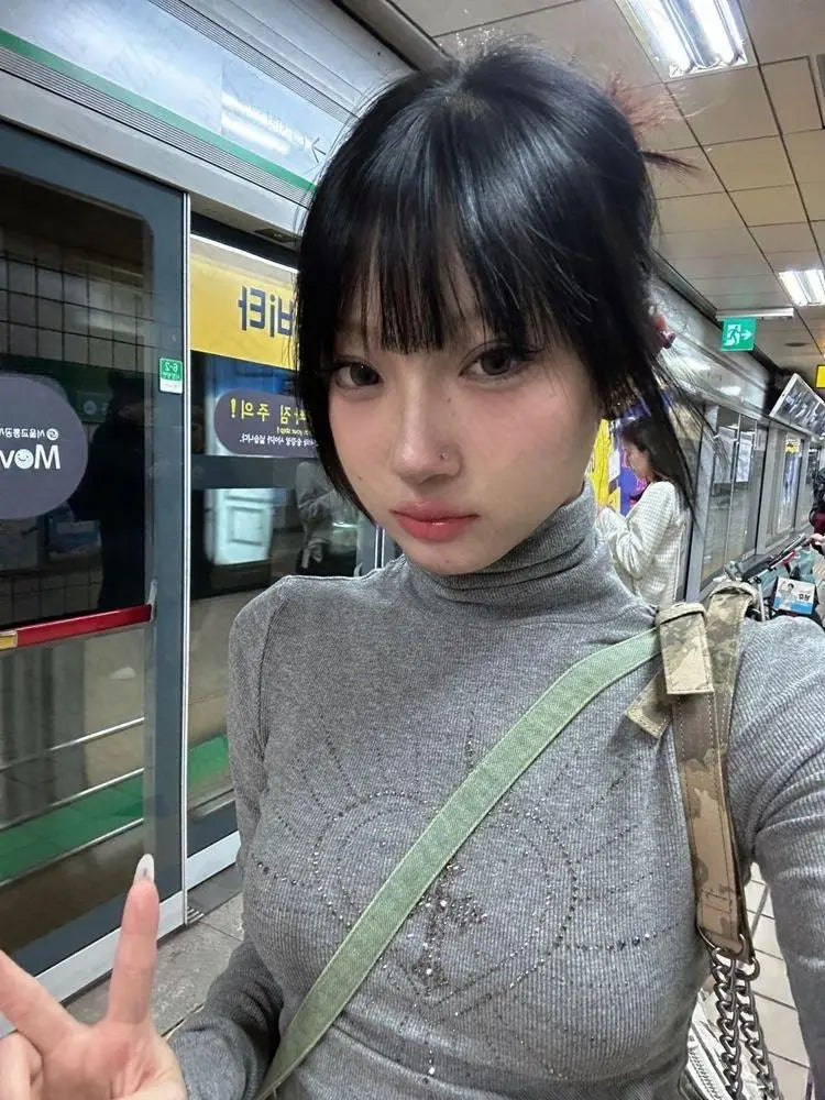 Model wearing the gray Modern Maven Top