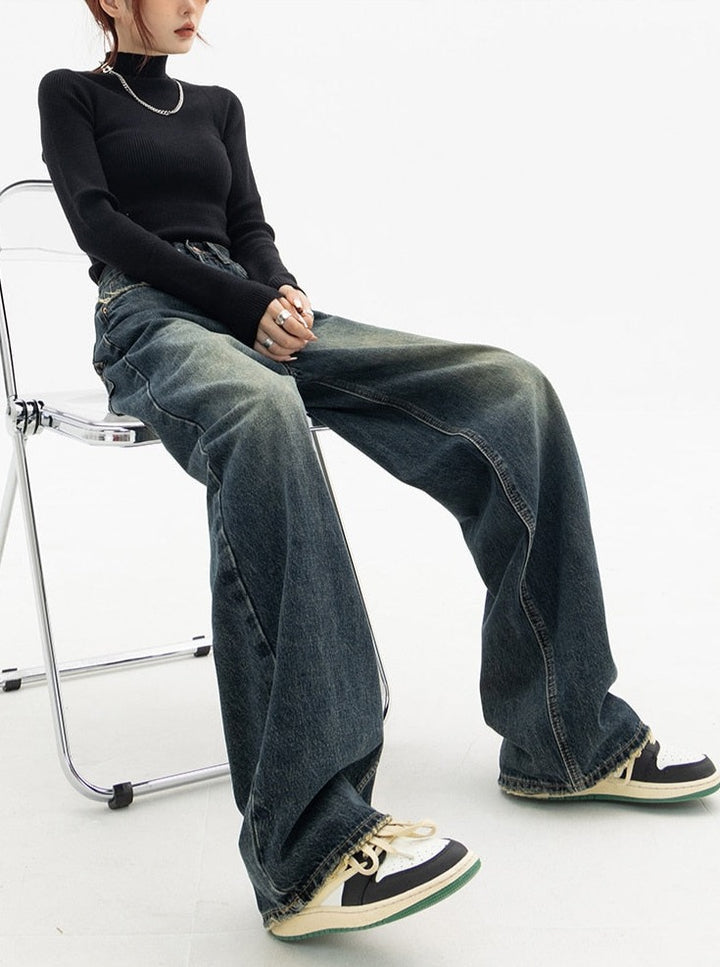 a model wearing the Vintage High Waist Women's Jeans while sitting