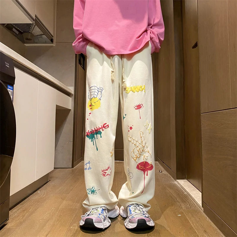 Model wearing the apricot Y2K Baggy Graphic Sweatpants