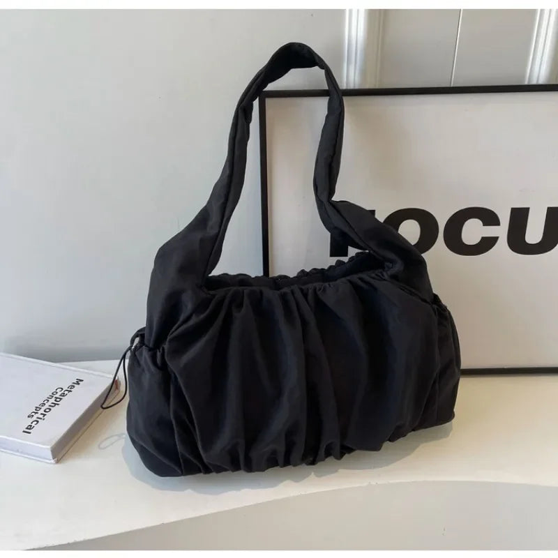 Front view of the black Wanderlust Sling Bag  