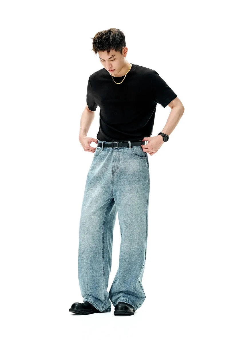 Model wearing the black Timeless Drift T-Shirt in a gray background