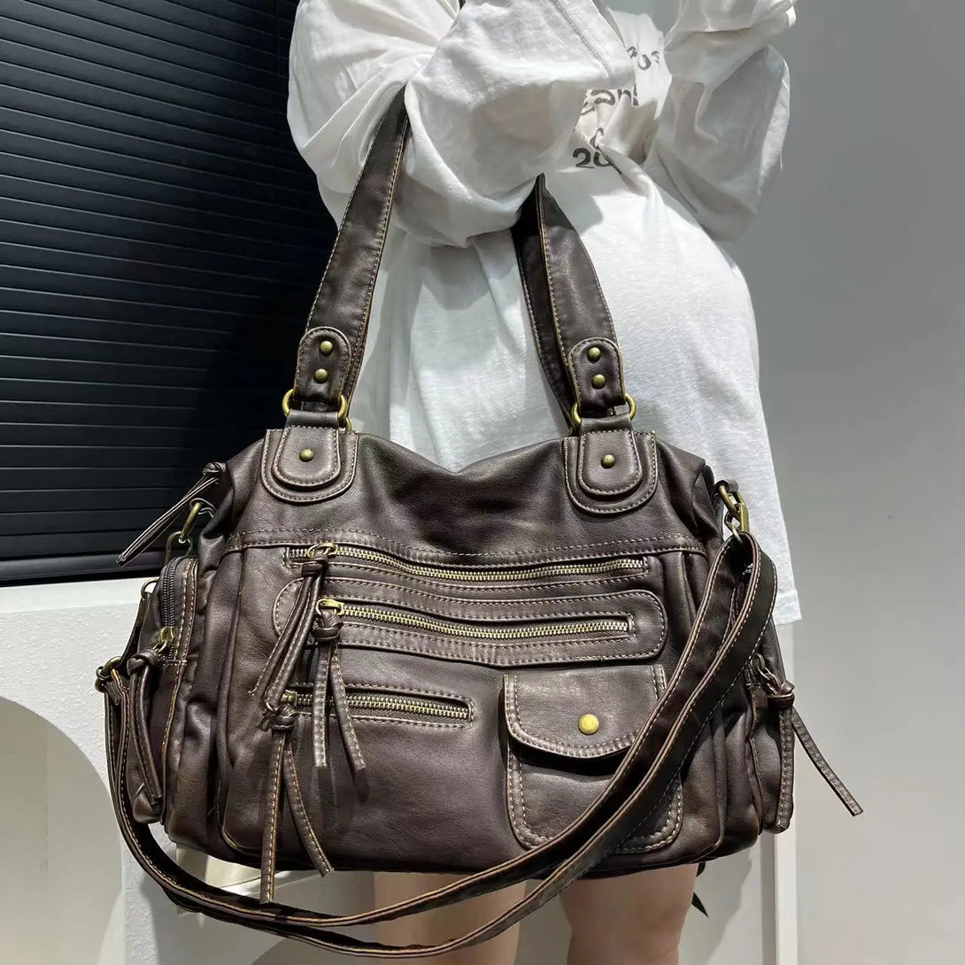 Model wearing the brown Multi-Compartment Zipper Handbag 