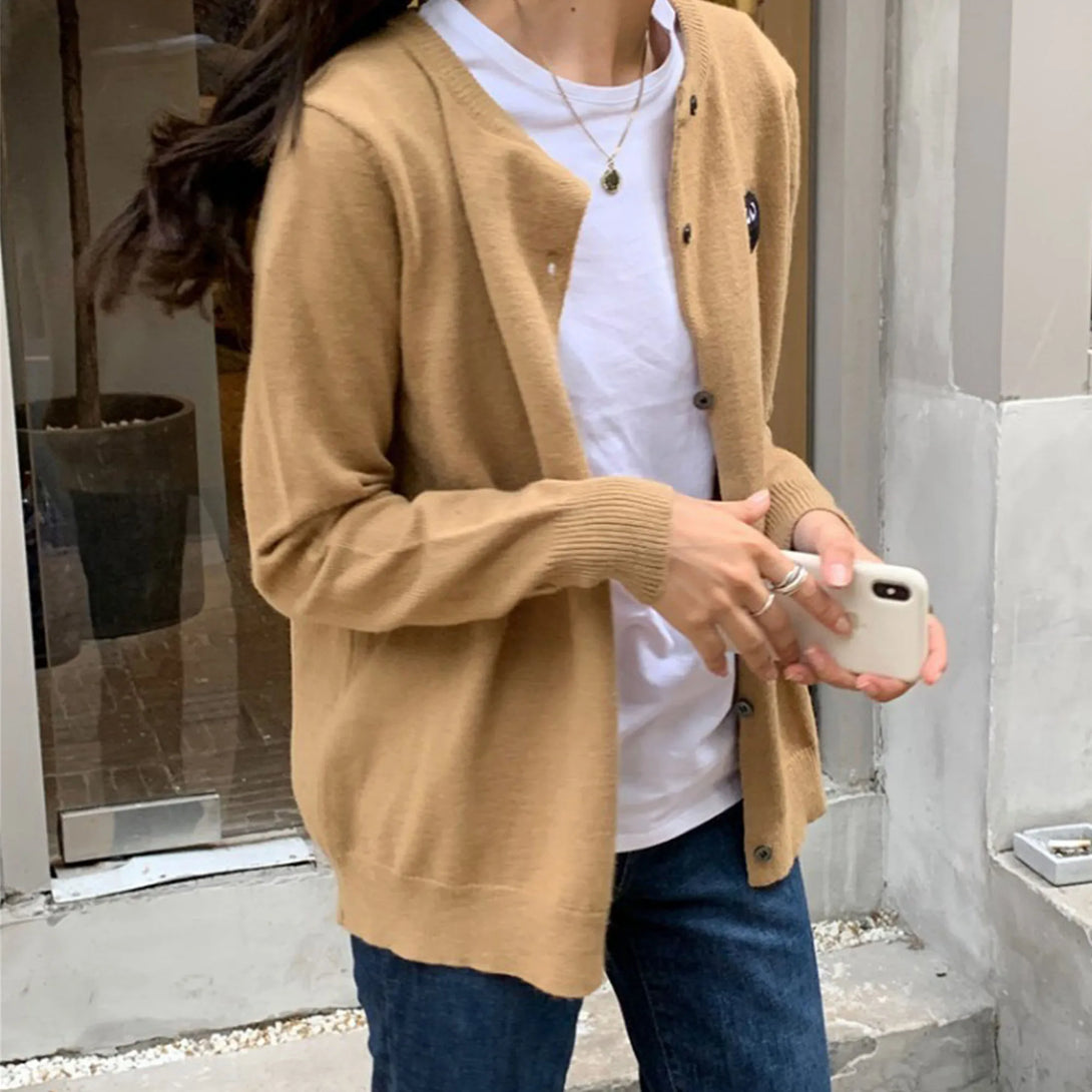 Model wearing the apricot Heart Patch Button-Up Sweater