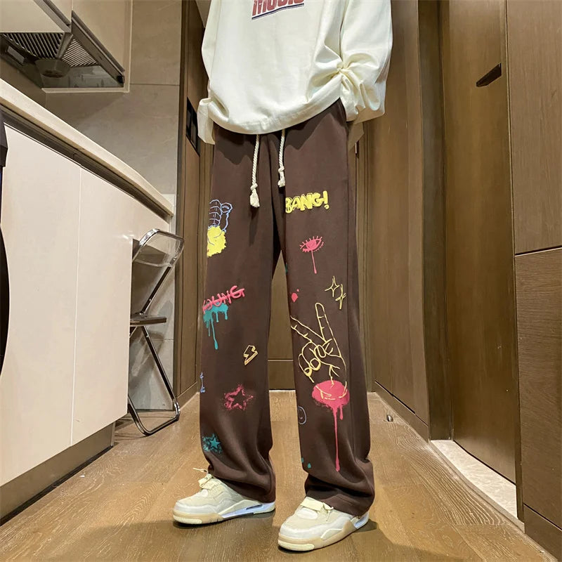 Model wearing the brown Y2K Baggy Graphic Sweatpants