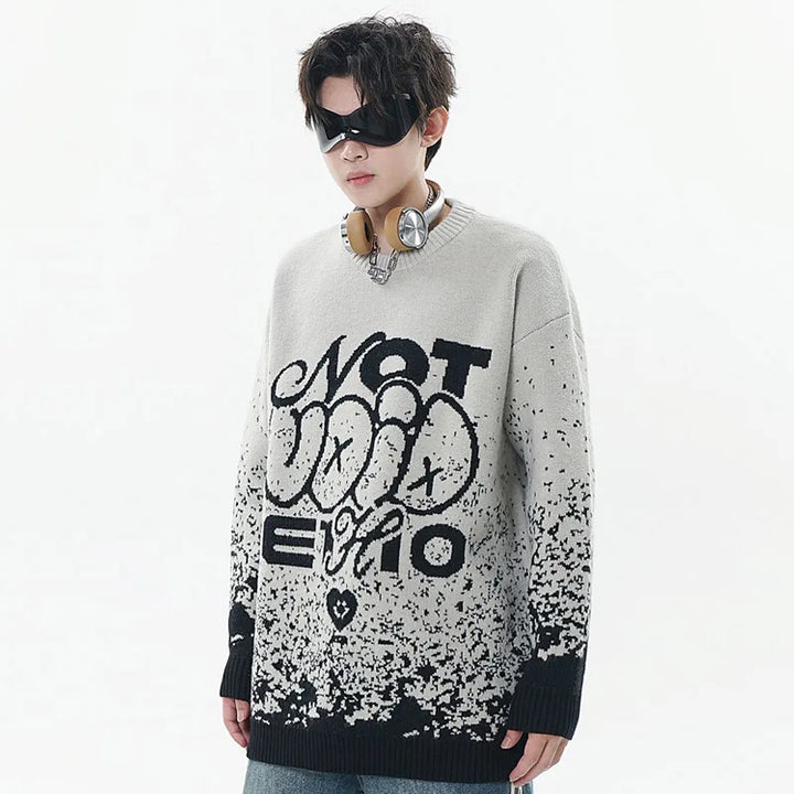 A model wearing the gray Y2K Sesame Jacquard Sweater while wearing glasses and headset