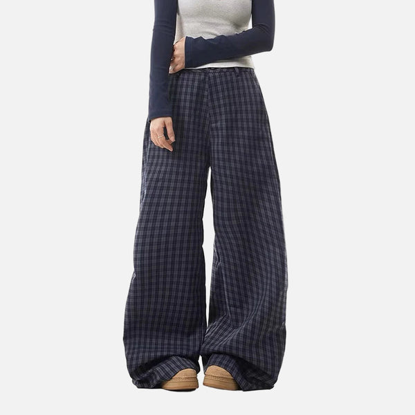Person wearing blue plaid wide-leg pants on a white background