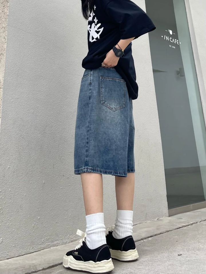 A model posing while wearing the Y2K Baggy Vintage Women's Jorts from DAXUEN
