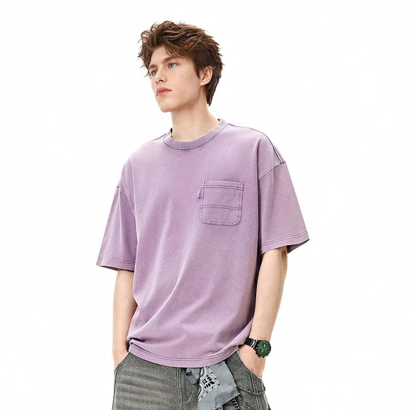Model wearing the light purple Classic Catchall T-Shirt in a gray background