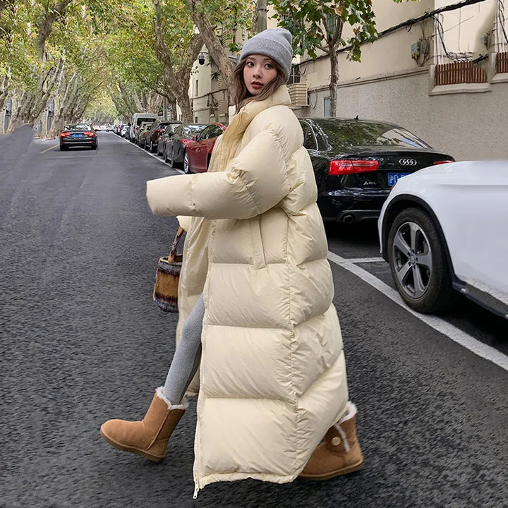 Model wearing The beige Women's Long Down Puffer Jacket on a Street
