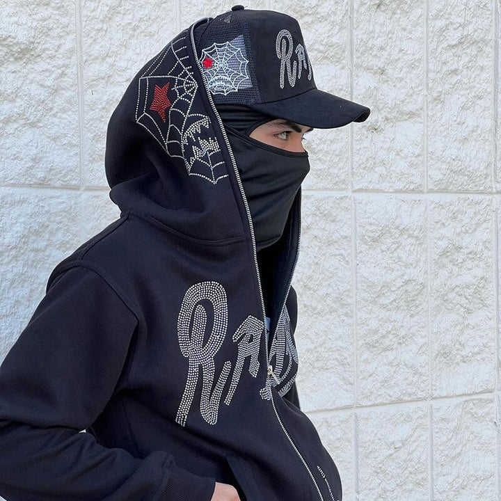 A model wearing the Y2k Black Zip-up Hoodie while wearing a face mask and  a cap