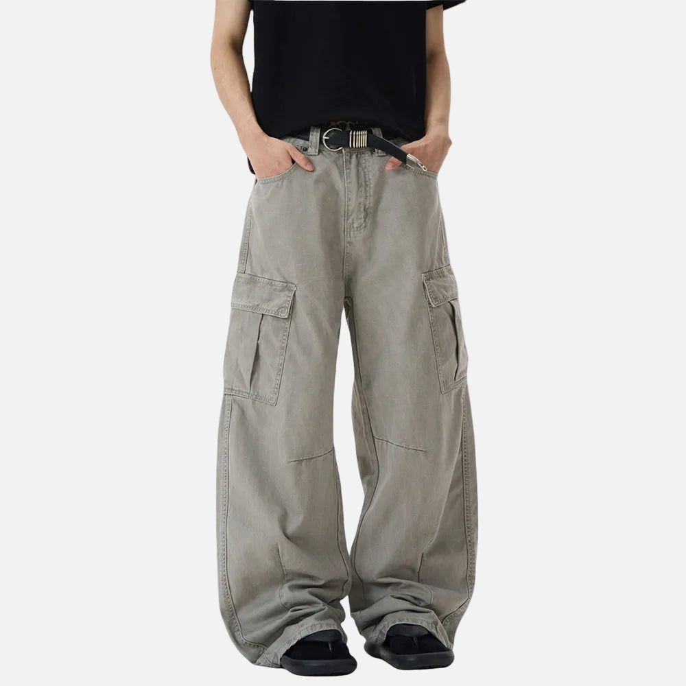 Person wearing beige cargo pants on a white background