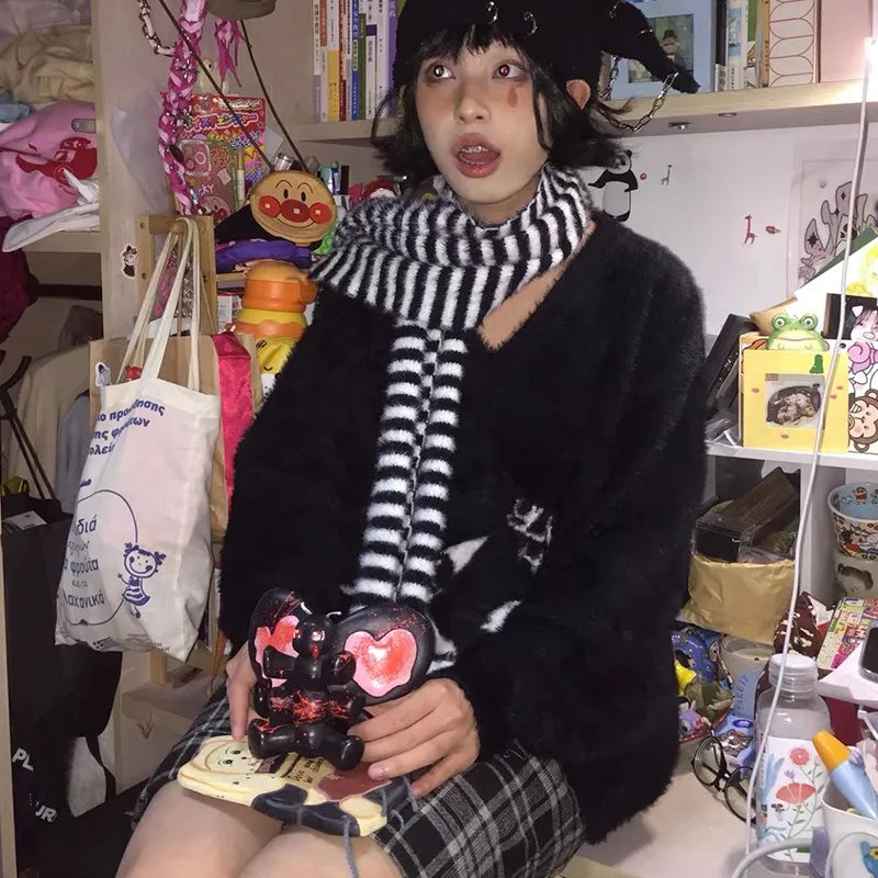 Modern wearing the black Skull Embrace Sweater