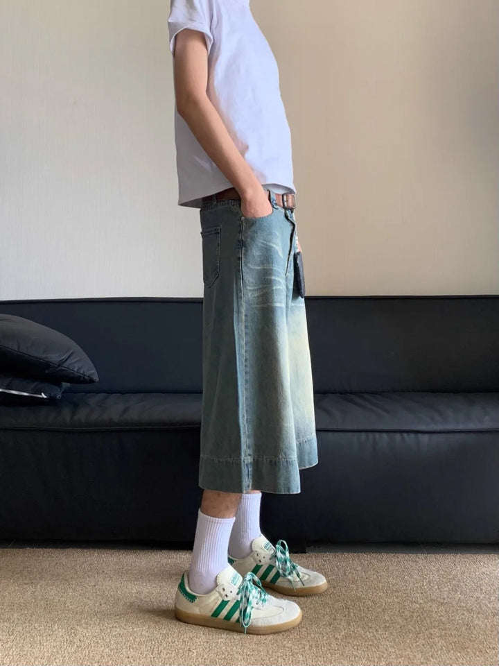 A model standing while wearing the Washed Blue Wide-leg Jorts from DAXUEN.