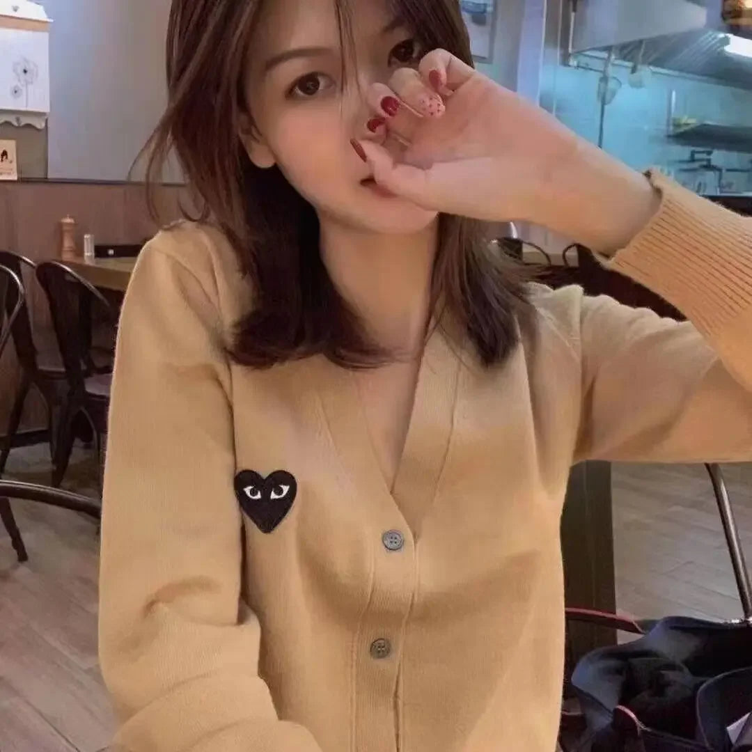 Model wearing the apricot Heart Patch Button-Up Sweater