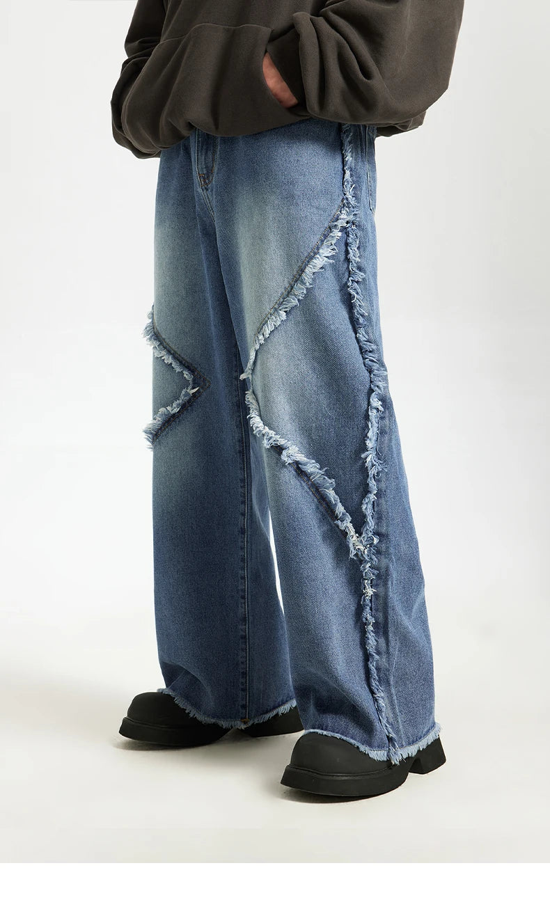 Model wearing the blue Frayed Flow Jeans in a gray background