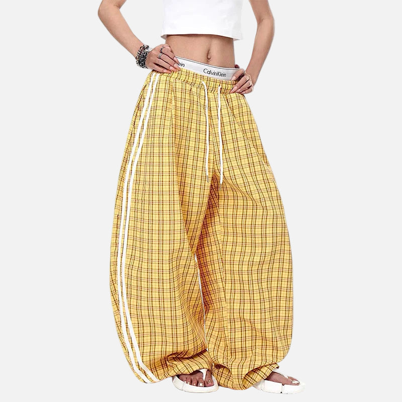 Yellow checkered pants with a Calvin Klein waistband on a white background