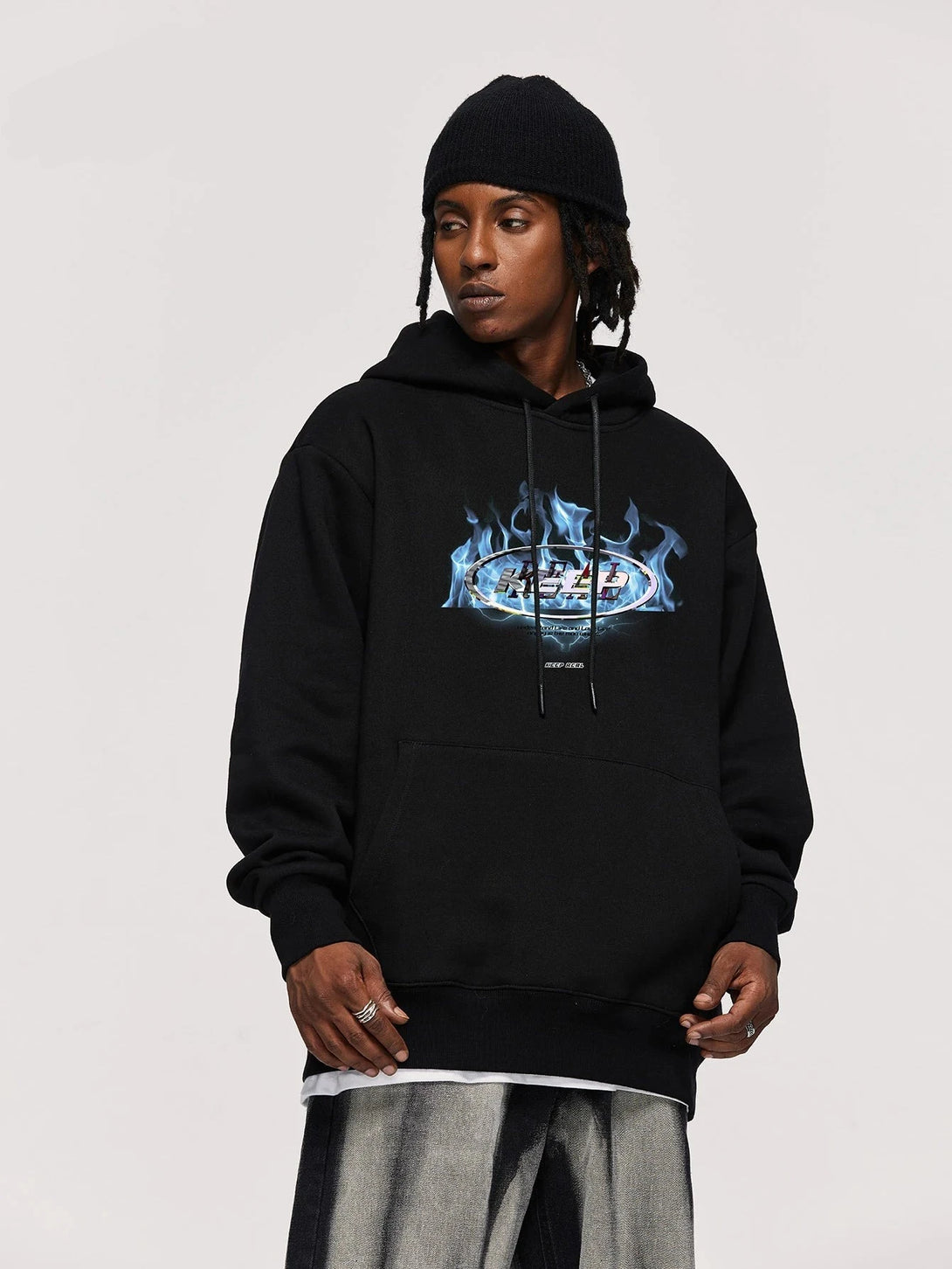 Model wearing the black Fire Wave Graphic Hoodie in a gray background