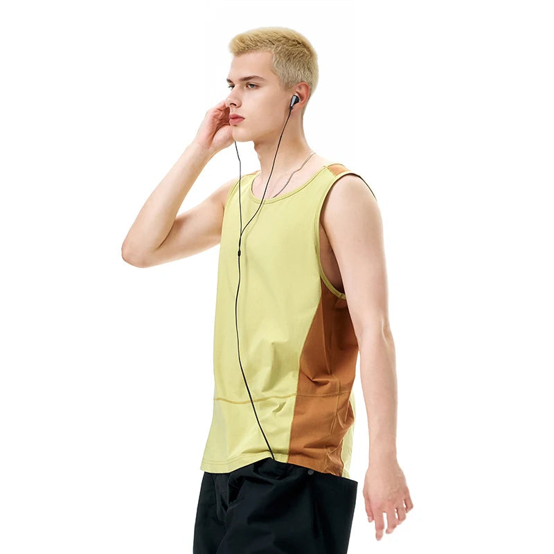 Model wearing the yellow Urban Edge Tank T-Shirt in a gray background