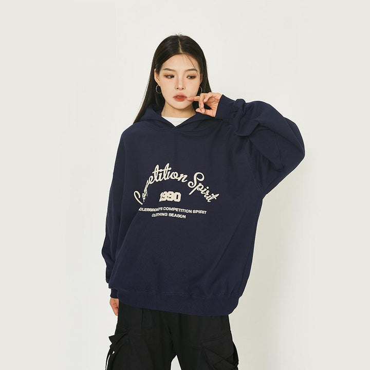 Model wearing the navy blue Loose Retro Endless road Hoodie in a gray background 