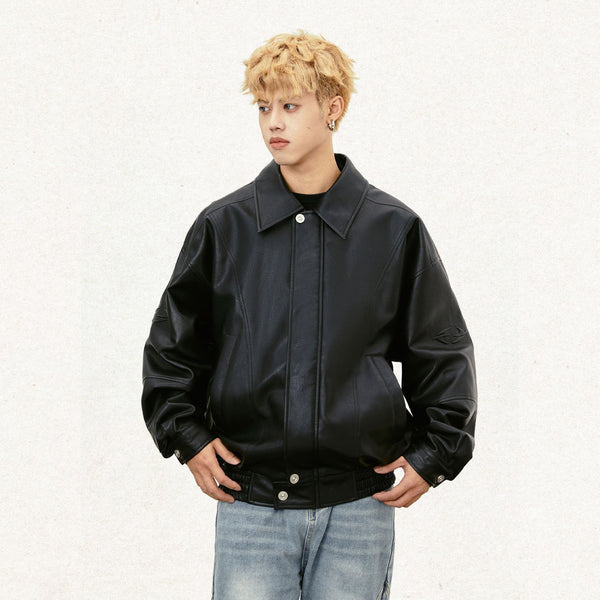 Model wearing the black Y2k Padded Leather Jacket in a gray background 