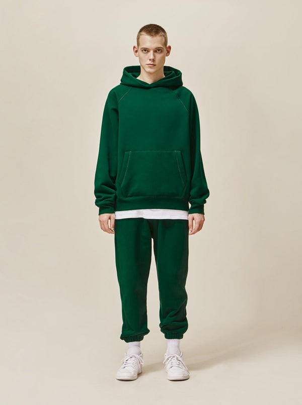 A guy wearing green explorer tracksuit front view
