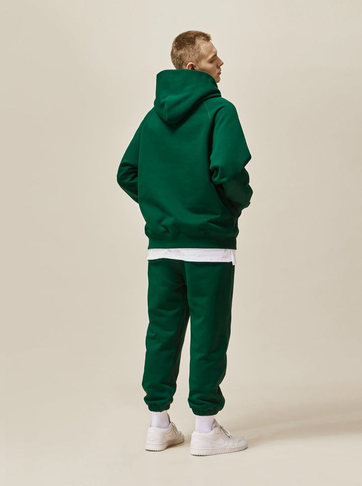 A guy wearing green Explorer Tracksuit back view