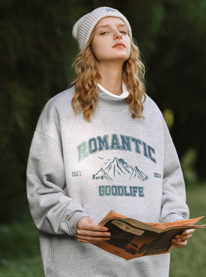 A girl wearing grey Good Life Sweatshirt
