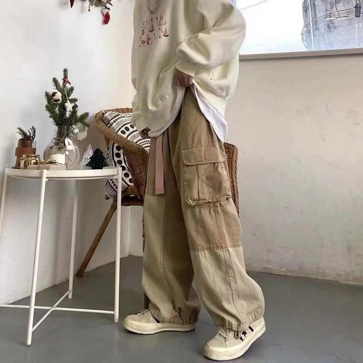 a model posing beside a table while wearing the khaki color of the Baggy Vintage Cargo Pants