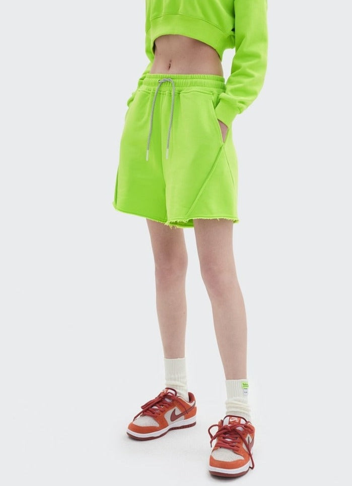 Girl wearing fluorescent green DAXUEN Jersey Lounge Shorts