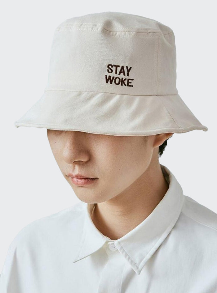 A guy wearing Stay Woke Bucket hat side view
