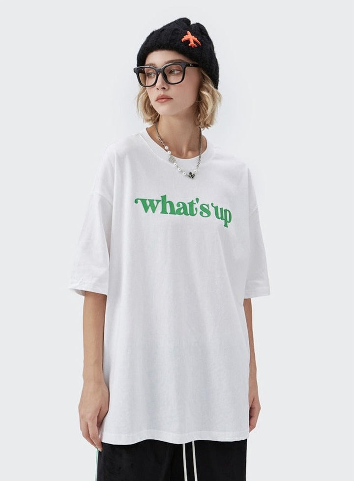 A girl wearing white What's up t shirt